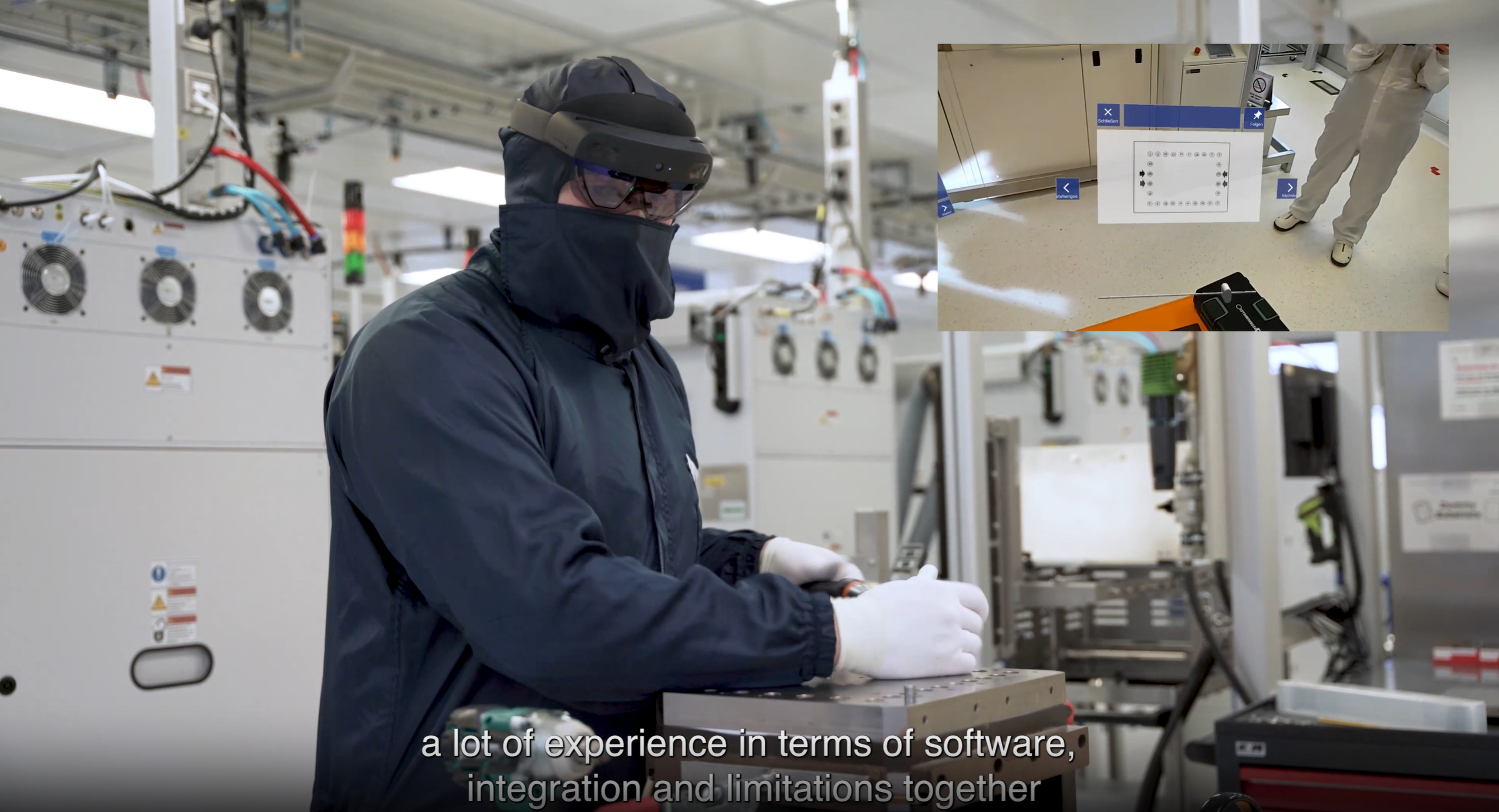 A man covered in protective clothes wears augmented reality glasses while he repairs equipment.